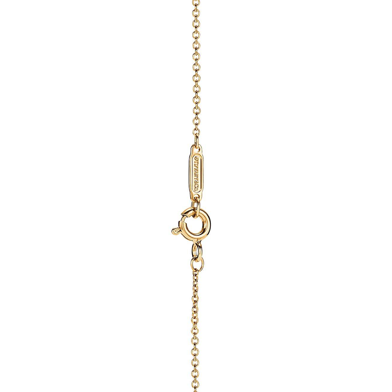 Tiffany T Diamond Pendant in 18k Gold with a Baguette Diamond